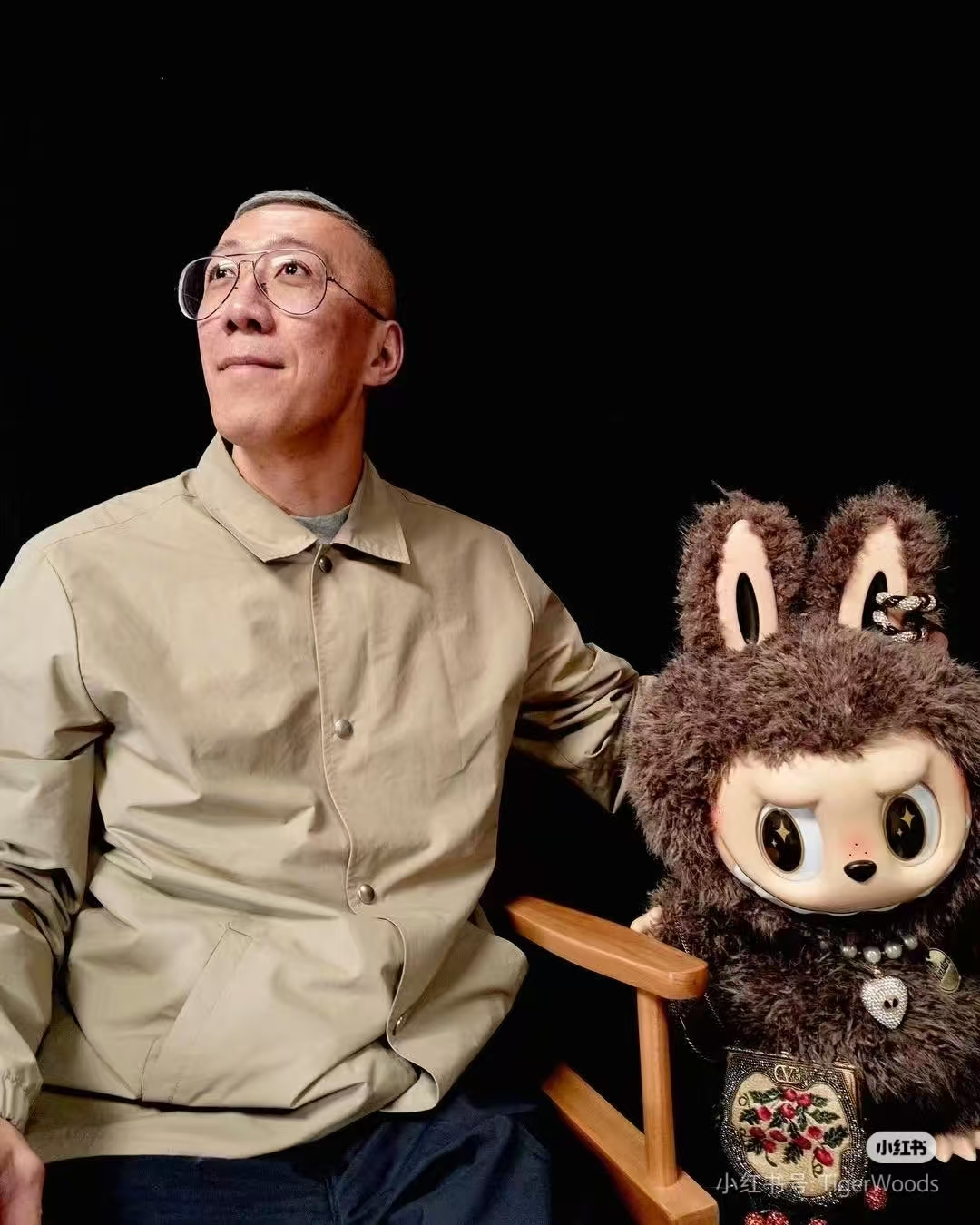 Labubu creator Kasing Lung with signature Labubu figure in a studio portrait